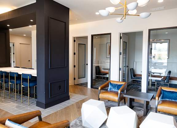 Resident lounge with private meeting rooms and seating areas at The Crest at South Point Apartments, McDonough