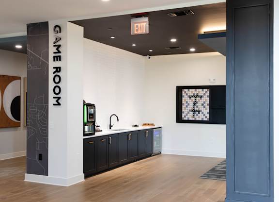 A room with a sign that says Game Room. at The Crest at South Point Apartments, Davenport