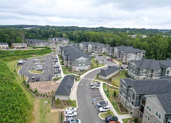 Aerial view of the rear apartment buildings, roads and parking areas at The Crest at Oakwood in Oakwood, GA.