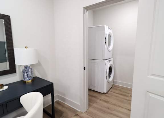 Stacked washer and dryer in laundry closet 1 at The Crest at South Point Apartments, McDonough, GA 30253