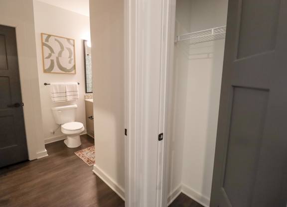 Hallway with linen closet and powder room access at The Wren Apartments, Lawrenceville, Georgia