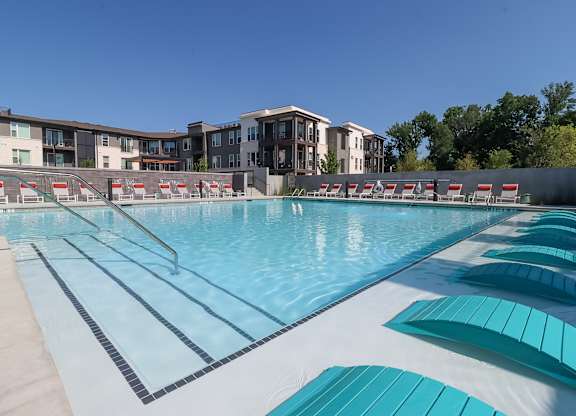 Resort style swimming pool with lounge chairs and lap lanes at The Wren Apartments, Lawrenceville, 30043