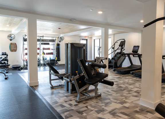 Fitness center with cardio and strength training equipment at The Wren Apartments, Lawrenceville