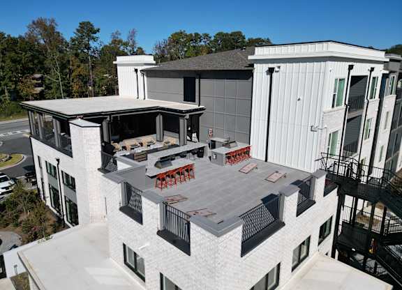 Rooftop terrace with outdoor kitchen and lounge seating at The Wren Apartments, Georgia