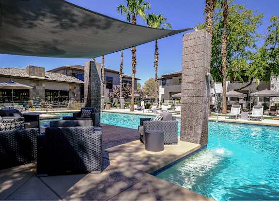 resort-inspired, covered lounging area and swimming pool at Avora apartments