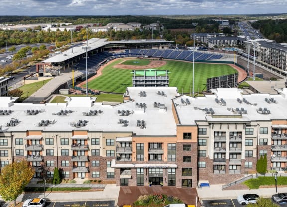 an aerial view of a baseball stadium and apartments