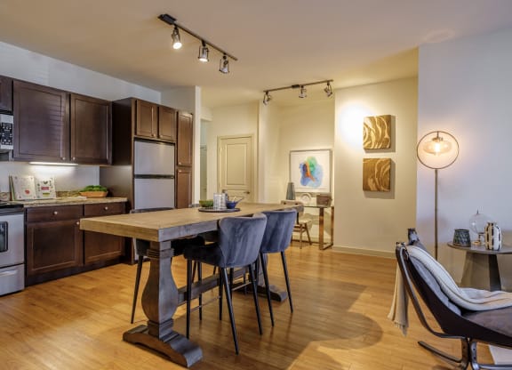 spacious open concept kitchen and living area with hardwood inspired flooring at The Pradera apartments