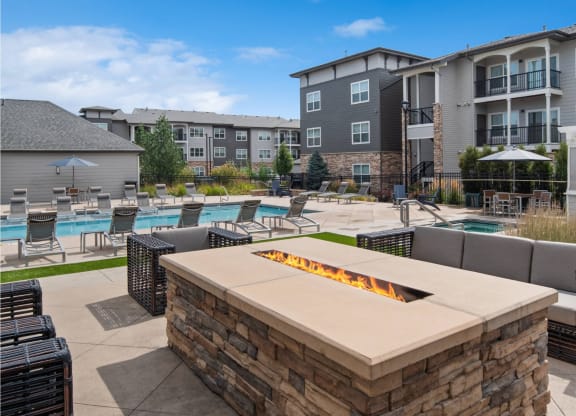 poolside patio and fireside lounging area with comfortable seating at Carrick Bend apartments