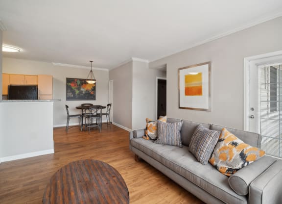 living room with wood-inspired flooring at Red Hawk Ranch apartments