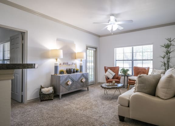 spacious living room with expansive windows at Stoneleigh on Spring Creek apartments