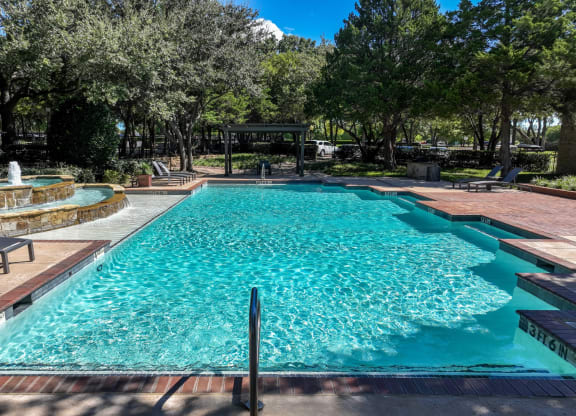 swimming pool with a fountain at Stoneleigh on Spring Creek apartments
