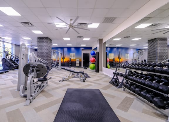 fitness center with weights and cardio machines at Roosevelt Square apartments