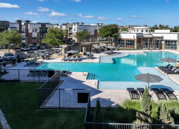 swimming pool with sun deck at Soho Parkway apartments