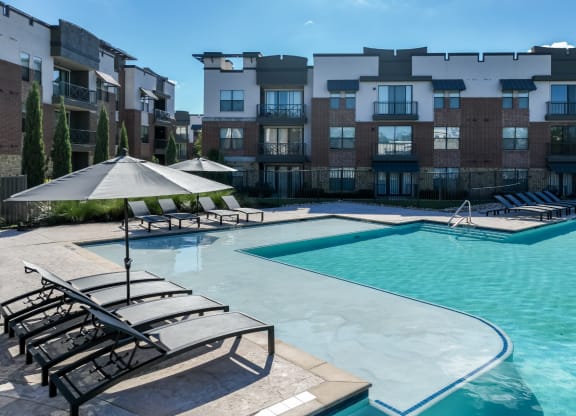 swimming pool with sun deck at Soho Parkway apartments