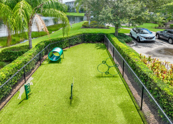 a backyard with a tennis court and tennis rackets