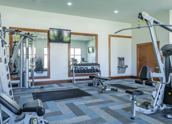 fitness center with free weights at The Pradera apartments