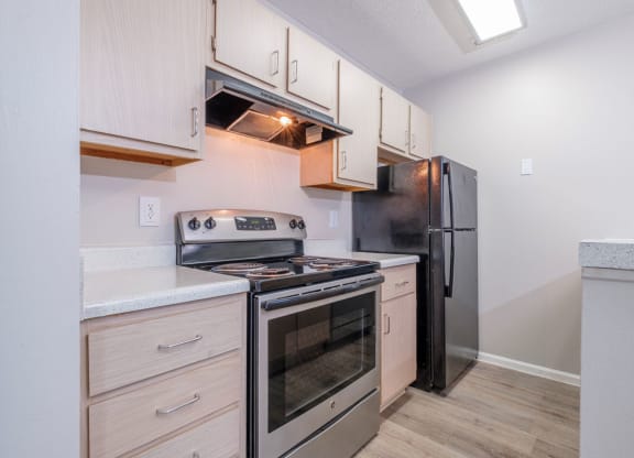 Heathermoor and Bedford Commons kitchen with stainless steel appliances and white cabinets