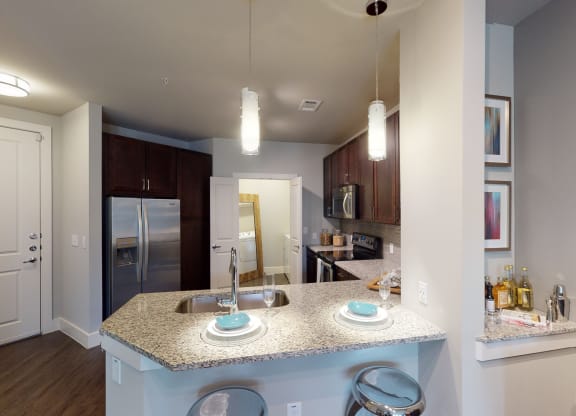 a kitchen with granite countertops and stainless steel appliances