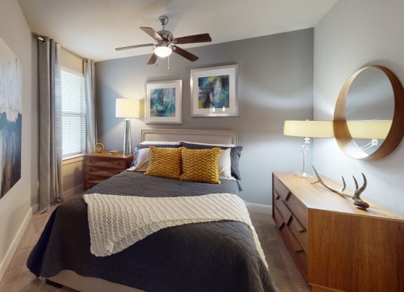 a bedroom with a bed and a ceiling fan