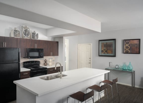 Brown cabinet kitchen with white countertops
