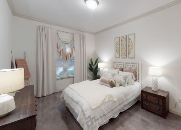 a bedroom with a bed and two night stands