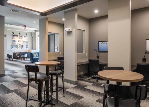 a lounge area with tables and chairs at Tinsley on the Park apartments