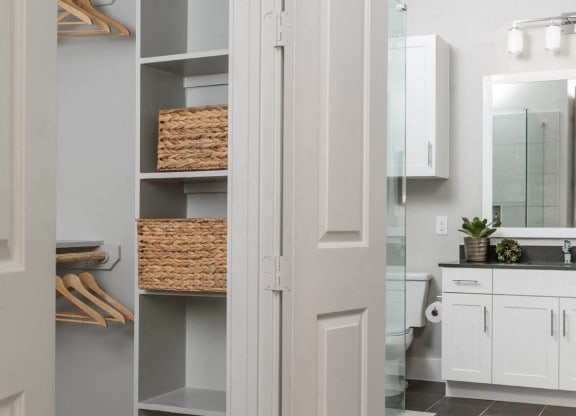 a bathroom and closet with shelving at Tinsley on the Park apartments