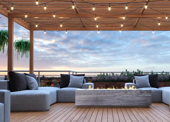 a roof terrace with couches and a fireplace at Tribeca NOMA apartments