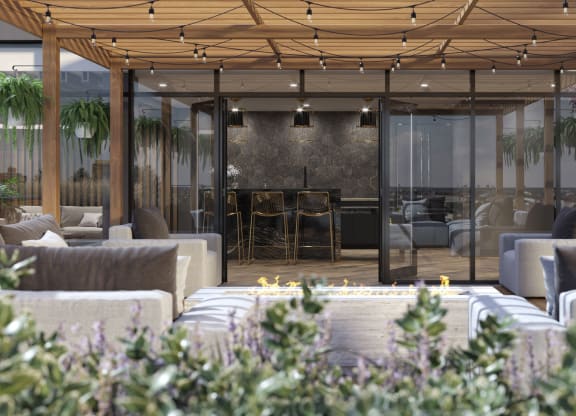 a lounge area with couches and chairs and glass walls at Tribeca NOMA apartments