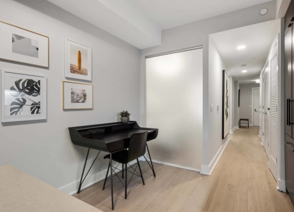 a home office with a black desk and chair at Tribeca NOMA apartments