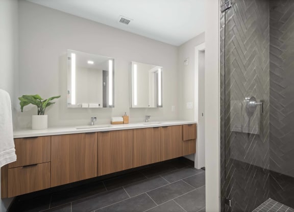 a large bathroom with two sinks and a shower at Tribeca NOMA apartments