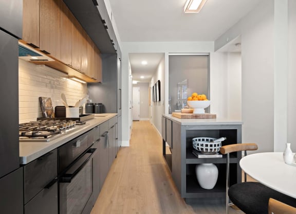 a kitchen with a long counter and a modern stove in Tribeca NOMA apartments