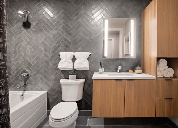 a bathroom with a toilet and a sink and a bath tub at Tribeca NOMA apartments