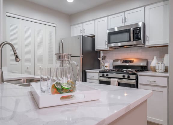 kitchen with stainless appliances and white cabinetry at The Residence at Christopher Wren apartments