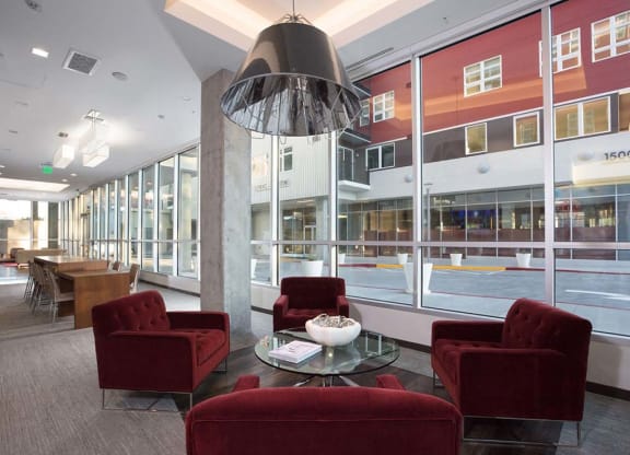 Indoor common area with red armchairs at Lyric, California