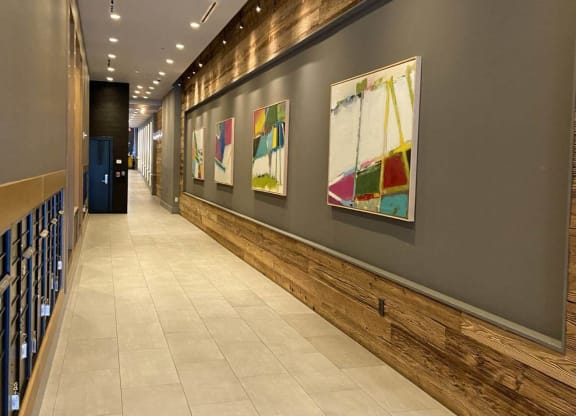 a long hallway with paintings on the wall at Tribeca NOMA apartments