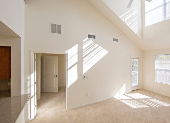 the living room and dining room of a two floor unit at Reveal Hackensack apartments