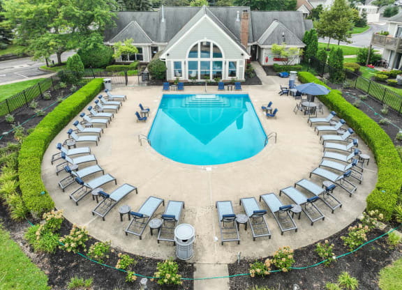 a pool with lounge chairs and umbrellas