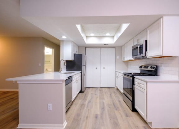 a kitchen with white cabinets