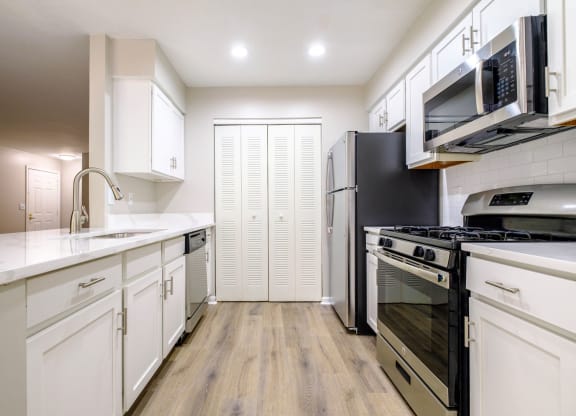 a kitchen with white cabinetry