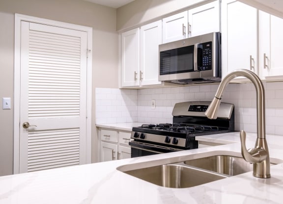 a kitchen with white cabinets