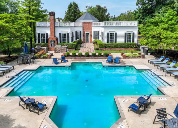 a swimming pool with chaise lounge chairs