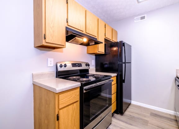 a kitchen with wooden cabinets