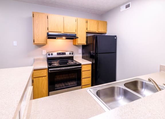 a kitchen with wooden cabinets