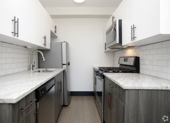 The Edison apartments modern kitchen with custom cabinetry and stainless appliances