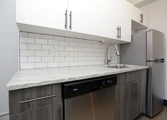 The Edison apartments kitchen with custom cabinetry and stainless appliances