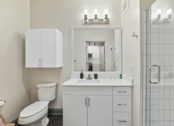 Trellis House apartments bathroom with custom cabinetry and designer lighting