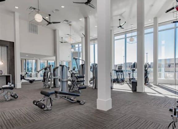 a gym with weights and cardio equipment at The Gabriella apartments