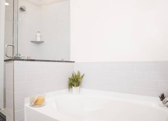 a luxury bathroom with a soaking tub and separate shower at The Gabriella apartments