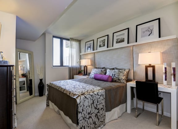 a bedroom with a bed and a desk with a chair at The Millennium, Virginia, 22202